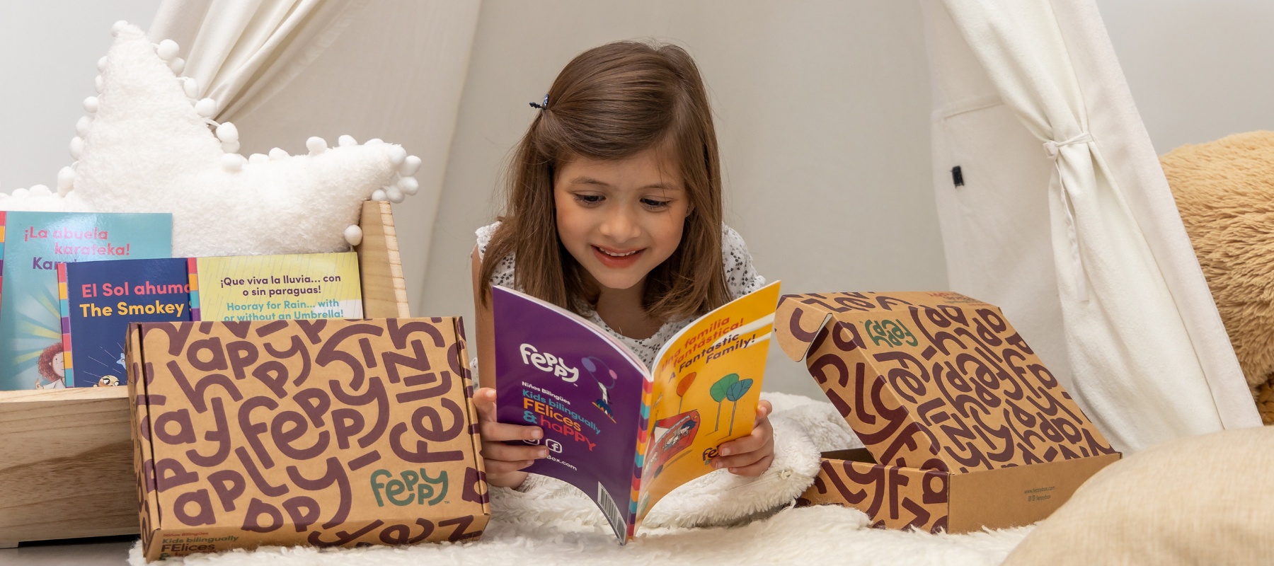 Child reading a book in a cozy room with a Feppy box and books around.